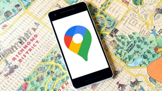Google Maps logo on a phone over a map.
